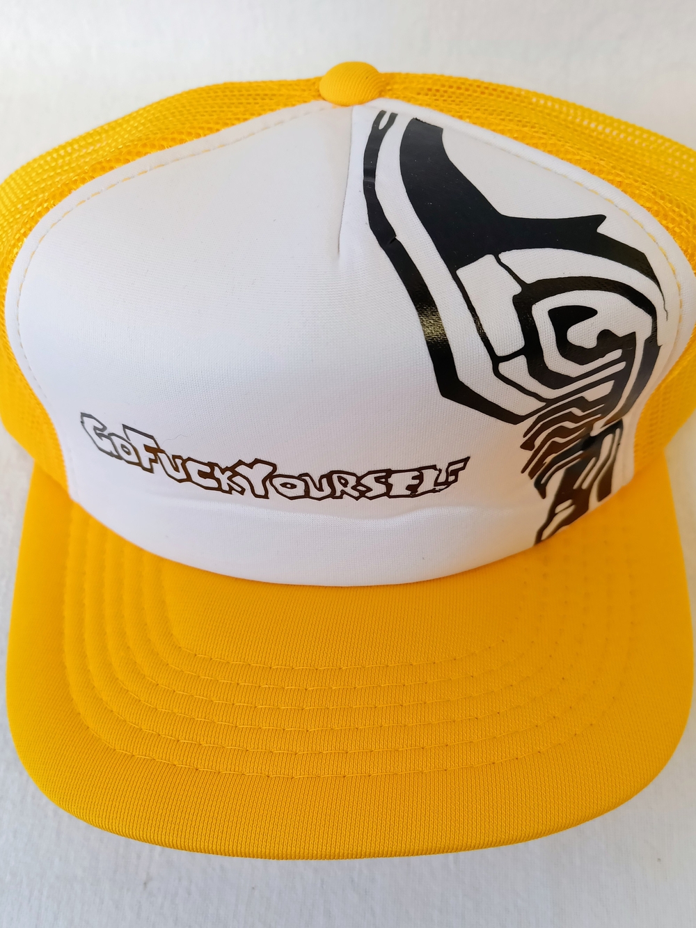 Yellow and White Trucker Hat with Bold Black Skull Graphic And Text